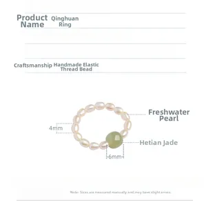 Detail view of 4mm freshwater pearls and 6mm Hetian jade bead on elastic ring