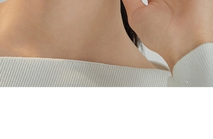 Close-up of elegant white knitted earrings featuring delicate vertical ribbed textures
