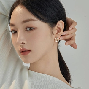 Elegant hollow floral wreath stud earrings with white pearls and gold metal finish