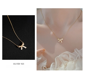 Detailed macro view of S925 silver gold bow pendant necklace with sparkling zircons