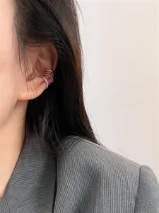 Close-up of three silver-toned ear cuffs featuring smooth, twisted, and pavé cubic zirconia designs
