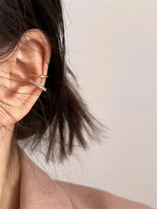Close-up of a double-layered gold ear cuff with shimmering pavé set cubic zirconia