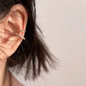 Double-layered gold ear cuff with minimalist band and micro-pave cubic zirconia stones