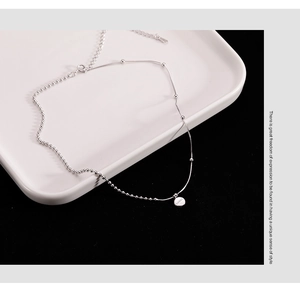 Detailed macro view of 925 sterling silver chain featuring lucky engraved pendant