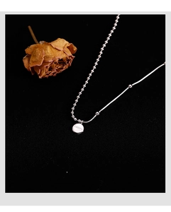 Detailed view of 925 sterling silver lucky pendant with round bead and snake chain