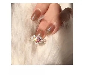 Detailed view of s925 silver ring with heart-cut pink zircon on a soft plush background