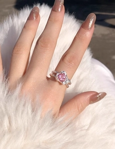 Close-up of S925 silver ring featuring a pink heart-shaped gem and side stones