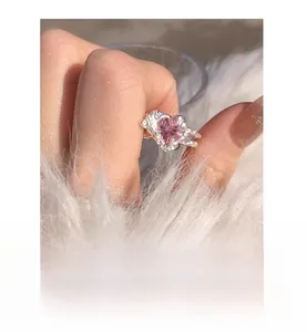 Detail of S925 silver ring featuring pink heart zircon and unique crinkled paper texture