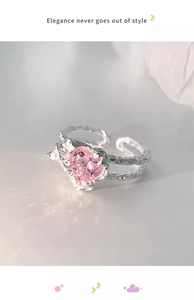 Detail of s925 silver ring featuring pink heart gem and textured hammered band