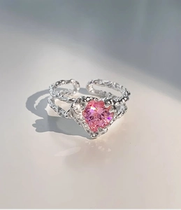 Macro detail of S925 silver ring featuring pink heart zircon and lava texture finish