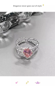 Detail of pink heart-shaped crystal ring with adjustable silver lava texture band