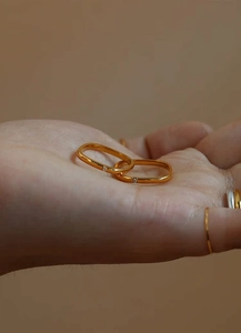 Detailed view of two minimalist gold thin rings with sparkling micro diamonds on hand
