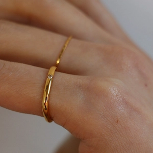 Minimalist square golden ring with sparkling diamond inlay and wavy streamlined design