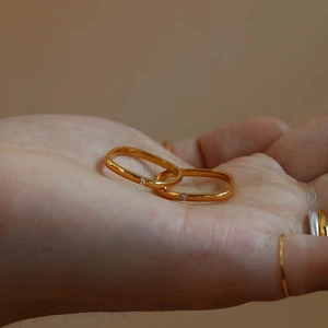 Minimalist square gold rings with small crystals set in a rounded rectangle design