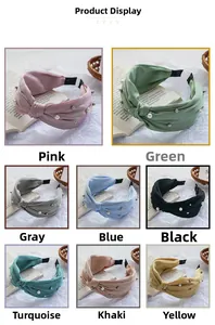Detail view of eight colorful pleated pearl headbands with knot design on textured background