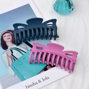 Large matte hair claw clips in navy blue and magenta with butterfly cutout design
