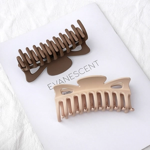 Matte finish large shark hair claws in dark brown and beige on minimalist fabric