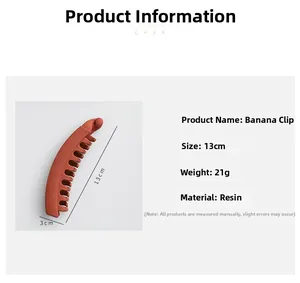 Macro product detail of 13cm matte resin banana hair clip in brick red showing exact dimensions