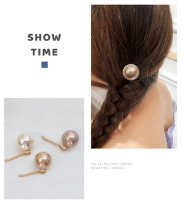 Detailed view of three pearl ponytail hair pins in white gold and purple colors