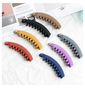 Detailed macro view of multi-color matte banana hair clips on a textured background