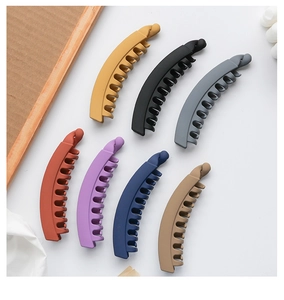 Detail of matte Morandi colored banana hair clips with textured shark teeth grip