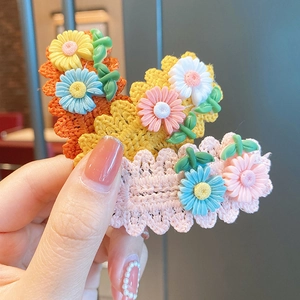 Handmade knitted daisy flower hair clips in orange, yellow and pink for little girls