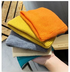 Stack of five colorful knitted beanies showing soft textures and rolled edges