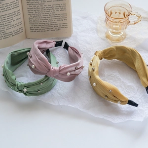 Three-piece set of twisted fabric headbands with elegant white pearls and bead embellishments