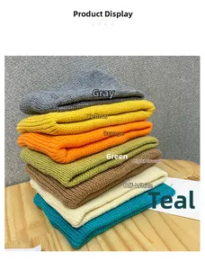 Stack of colorful knitted sports headbands in grey yellow orange green and beige tones
