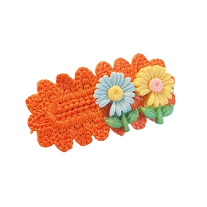 Cute knitted flower hair clip with daisy decor for girls in vibrant orange and blue