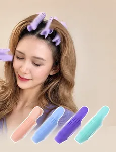 Detail showing colorful hair root volumizing clips in purple pink blue and green colors