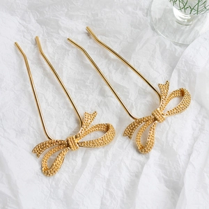 Minimalist golden U-shaped hair pins with elegant frosted metal bow design for women