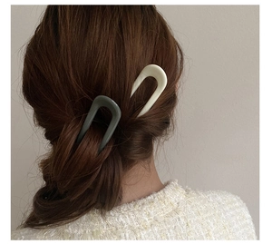 Detailed back view of model wearing minimalist U-shaped hair pins in resin finish