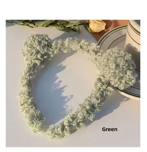 Close-up of green plush bear ear headband made of soft sherpa fleece for face washing