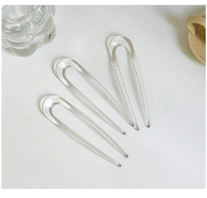 Three-piece set of transparent U-shaped resin hairpins shown on a minimalist white background