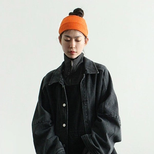 Minimalist bright orange knitted sports headband for women on model in casual outdoor style