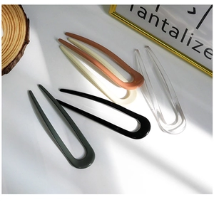 U-shaped hair sticks in five assorted colors including dark green, ivory and amber finish