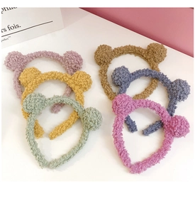 Detailed close-up of six colorful plush bear ear headbands in various soft pastel colors
