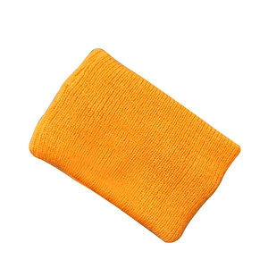 Bright orange knitted sports headband with a ribbed texture for women on white background
