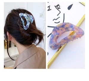Close-up of large acetate hair claws with blue and pink marble patterns for women