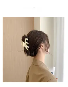 Elegant large cream marble acetate hair claw clip for a secure back head hairstyle