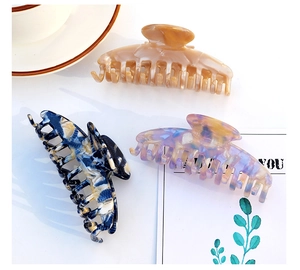 Trio of elegant acetate hair claws in amber, marble, and violet patterns for thick hair