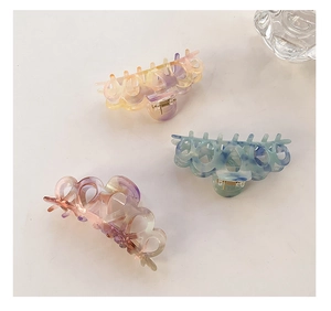 Three-piece set of large marbled acetate hair claws with circular hollow out design