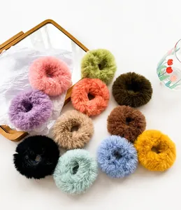 Detailed flat lay of plush fuzzy hair scrunchies in 11 autumn winter colors