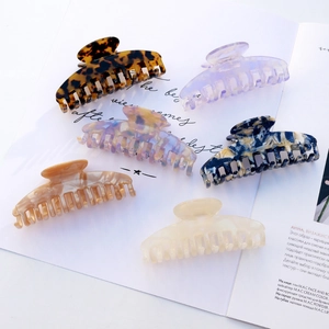 Elegant acetate hair claw clips set in various marble and tortoiseshell patterns