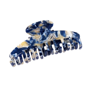 Elegant large acetate hair claw clip with blue and cream marble texture on white background