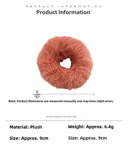 Detail of plush orange-pink hair scrunchie with 9cm diameter and soft faux fur texture