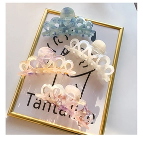 Detail of large acetate hair claws with marble texture in various pastel colors