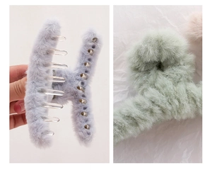 Close-up of soft plush hair claws in light blue and green with a fluffy texture