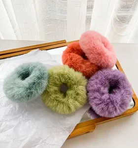 Close-up of five colorful plush rabbit ear hair ties in high-density faux fur texture